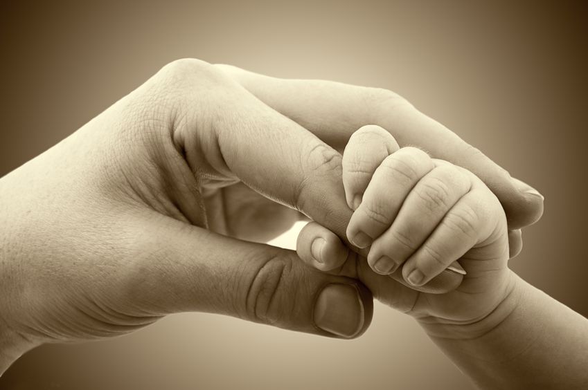 17561693 - concept of love and family. hands of mother and baby closeup